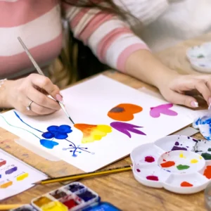 Close up of a person's hands painting