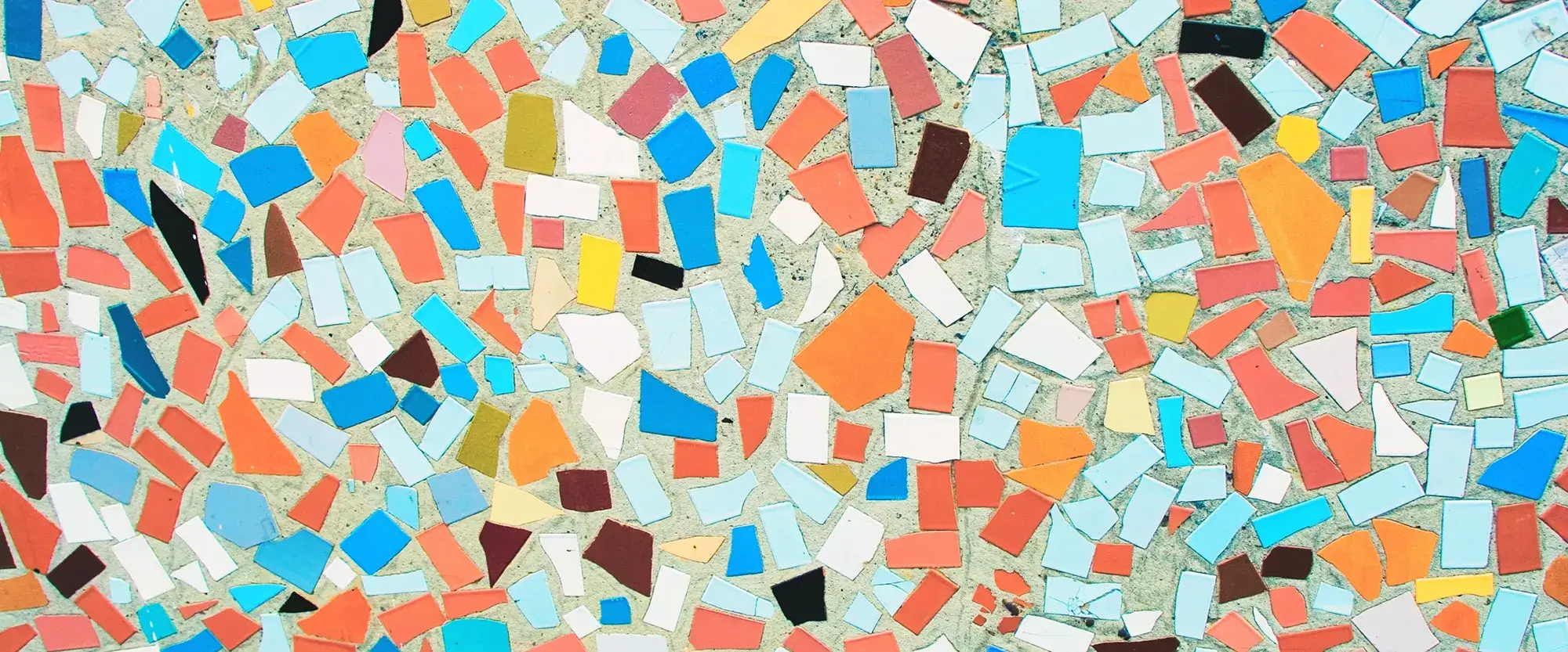 An overhead shot of multicolor tiles in a mosaic