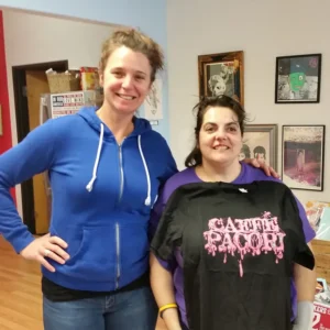 Two people standing next to each other and smiling at the camera